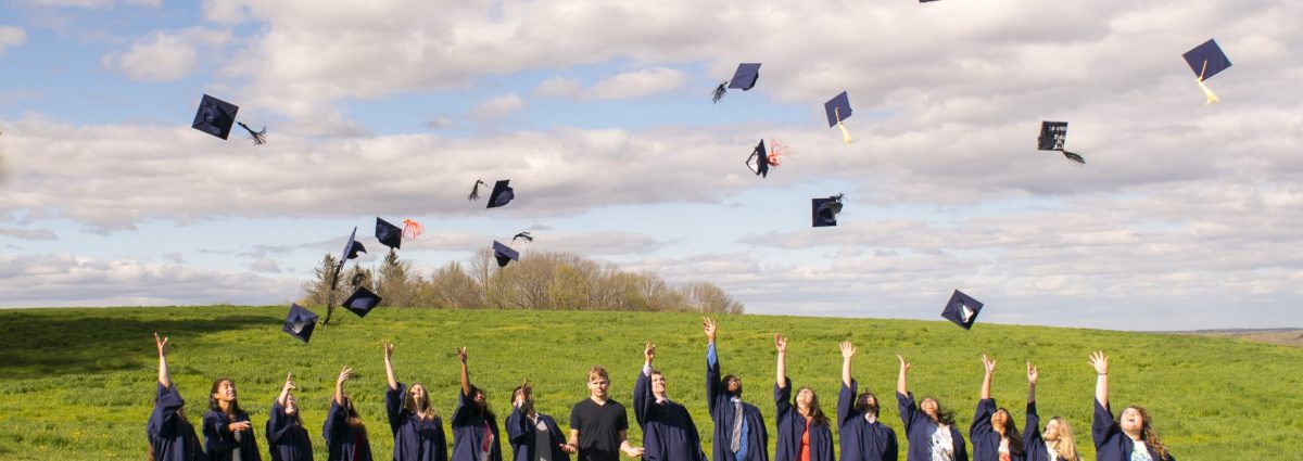 Group of students in throwing caps in to air